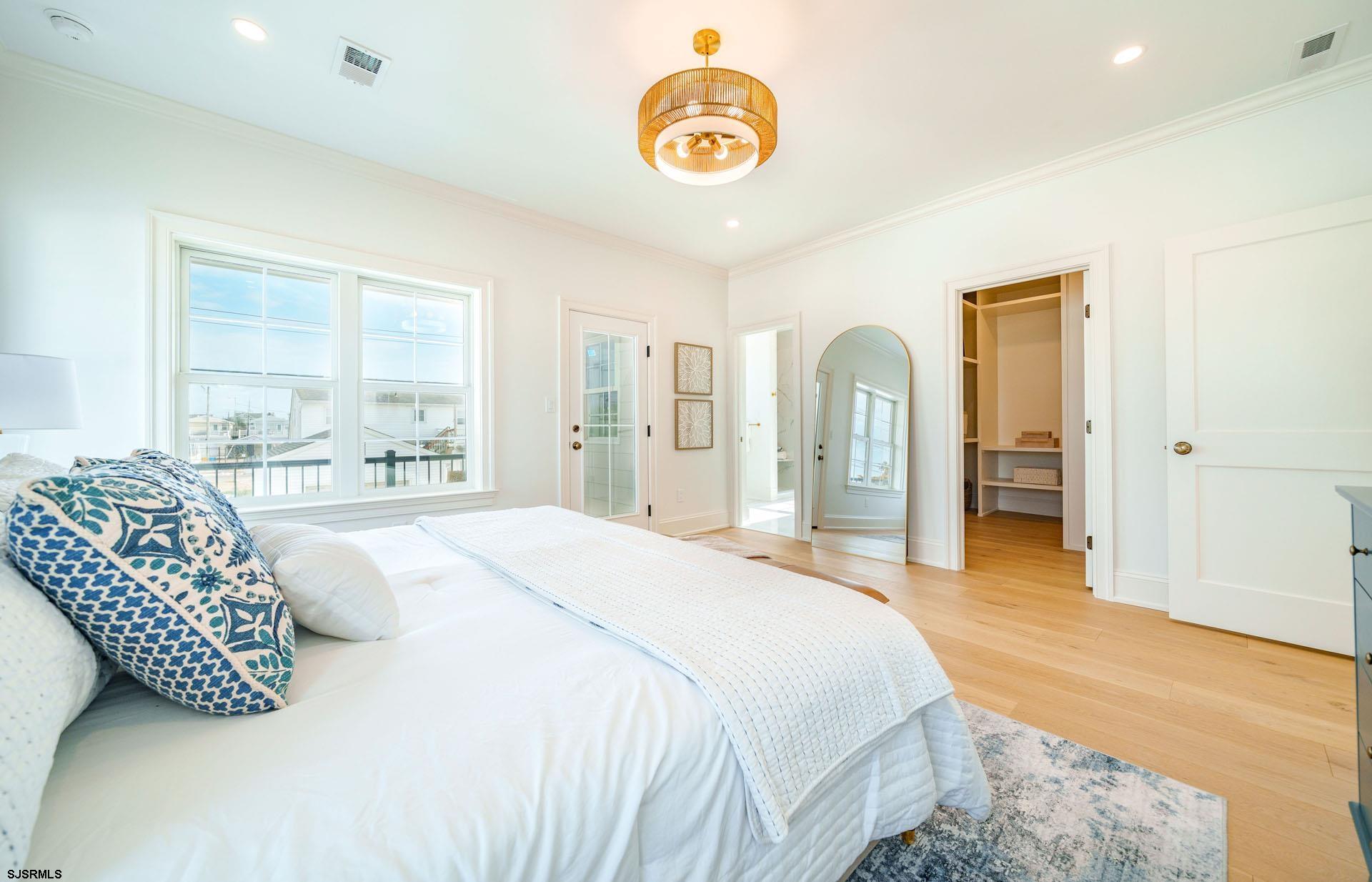 5217 Simpson Avenue Ocean City, NJ 08226 - Photo 10 of 52 a spacious bedroom with a bed and a large mirror