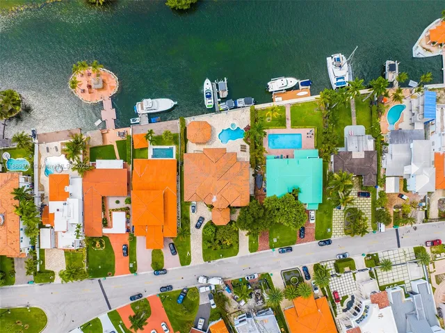 a view of a lake with a table and chairs under an umbrella