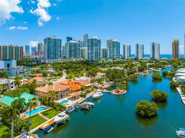 an aerial view of residential houses with outdoor space and lake view