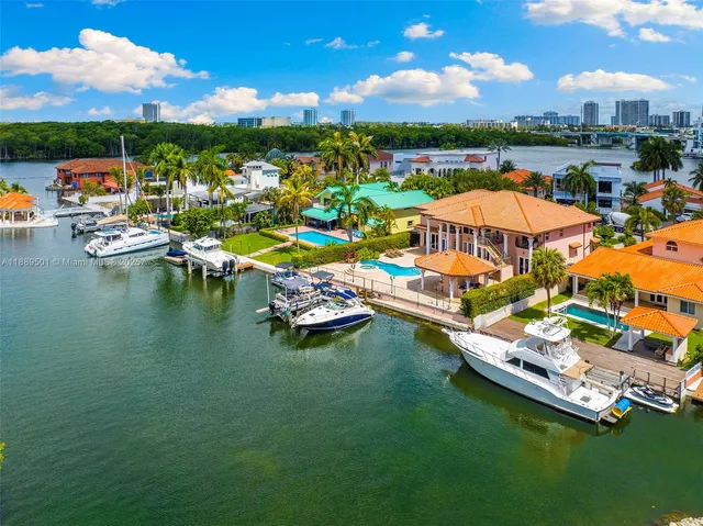 a aerial view of a house with swimming pool and a chairs