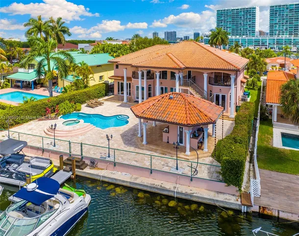 an aerial view of residential houses with outdoor space and lake view