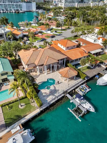 an aerial view of a house with a garden swimming pool and outdoor seating