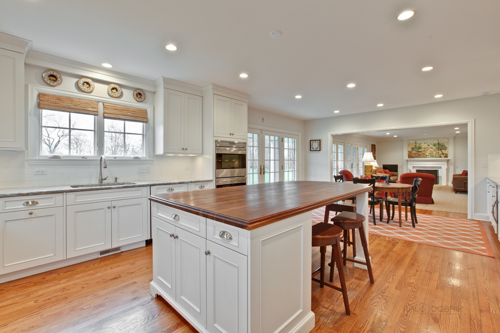 455 Landreth Lane Northfield, IL 60093 - Photo 13 of 31 a kitchen with stainless steel appliances granite countertop table chairs sink and cabinets