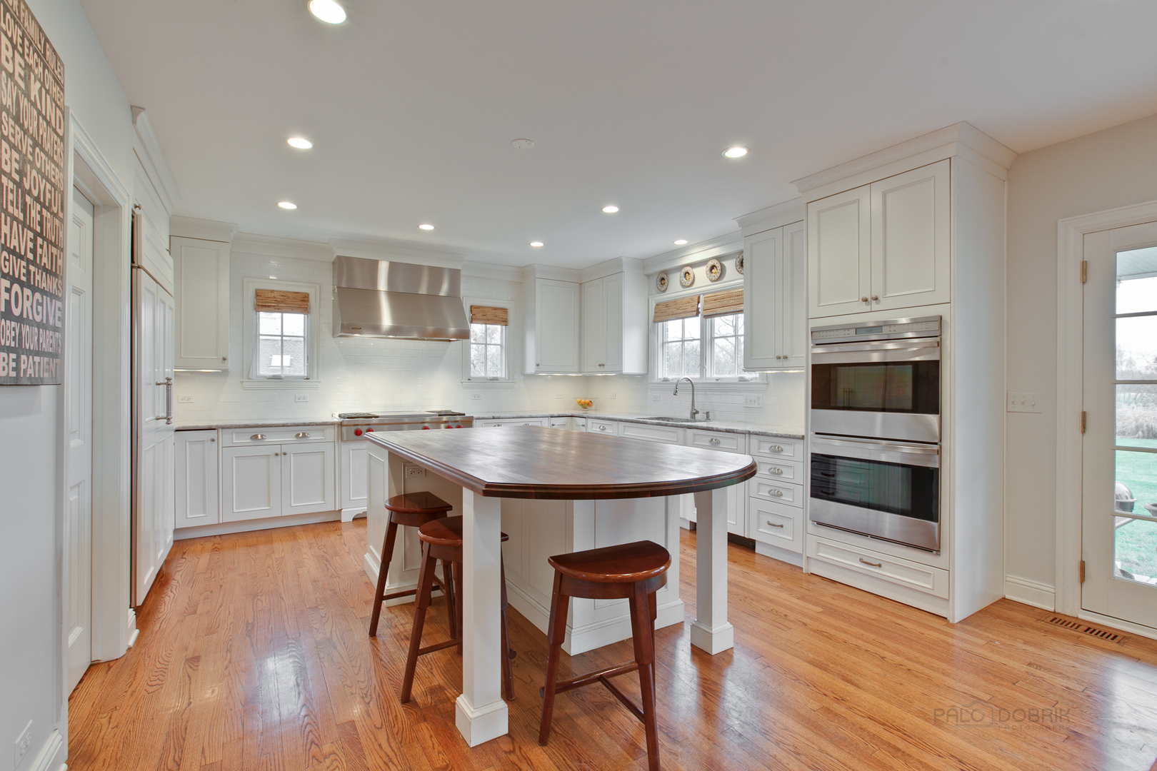 455 Landreth Lane Northfield, IL 60093 - Photo 14 of 31 a kitchen with kitchen island a dining table chairs cabinets and stainless steel appliances