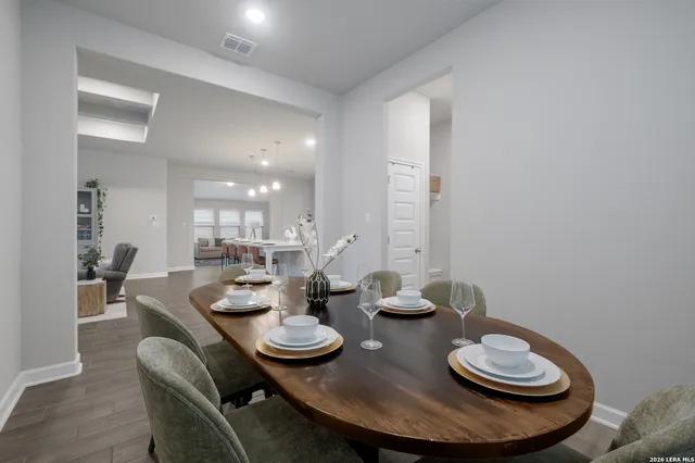 a dining room with furniture and wooden floor