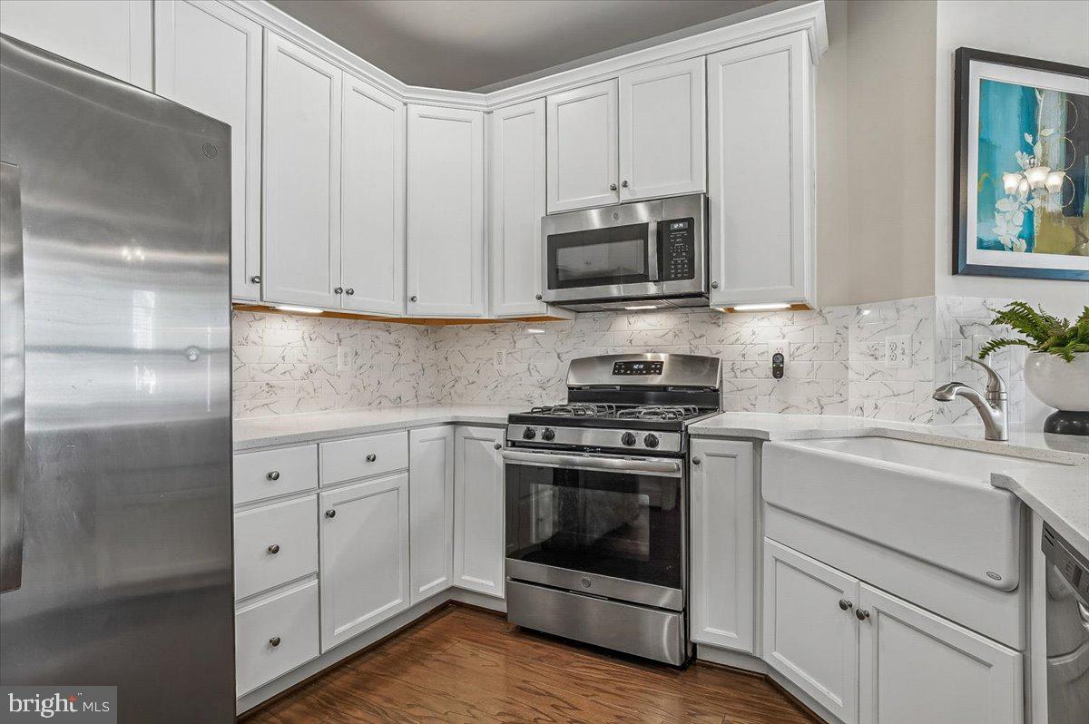 2638 Dragon Fly Way Odenton, MD 21113 - Photo 7 of 45 a kitchen with white cabinets and white appliances