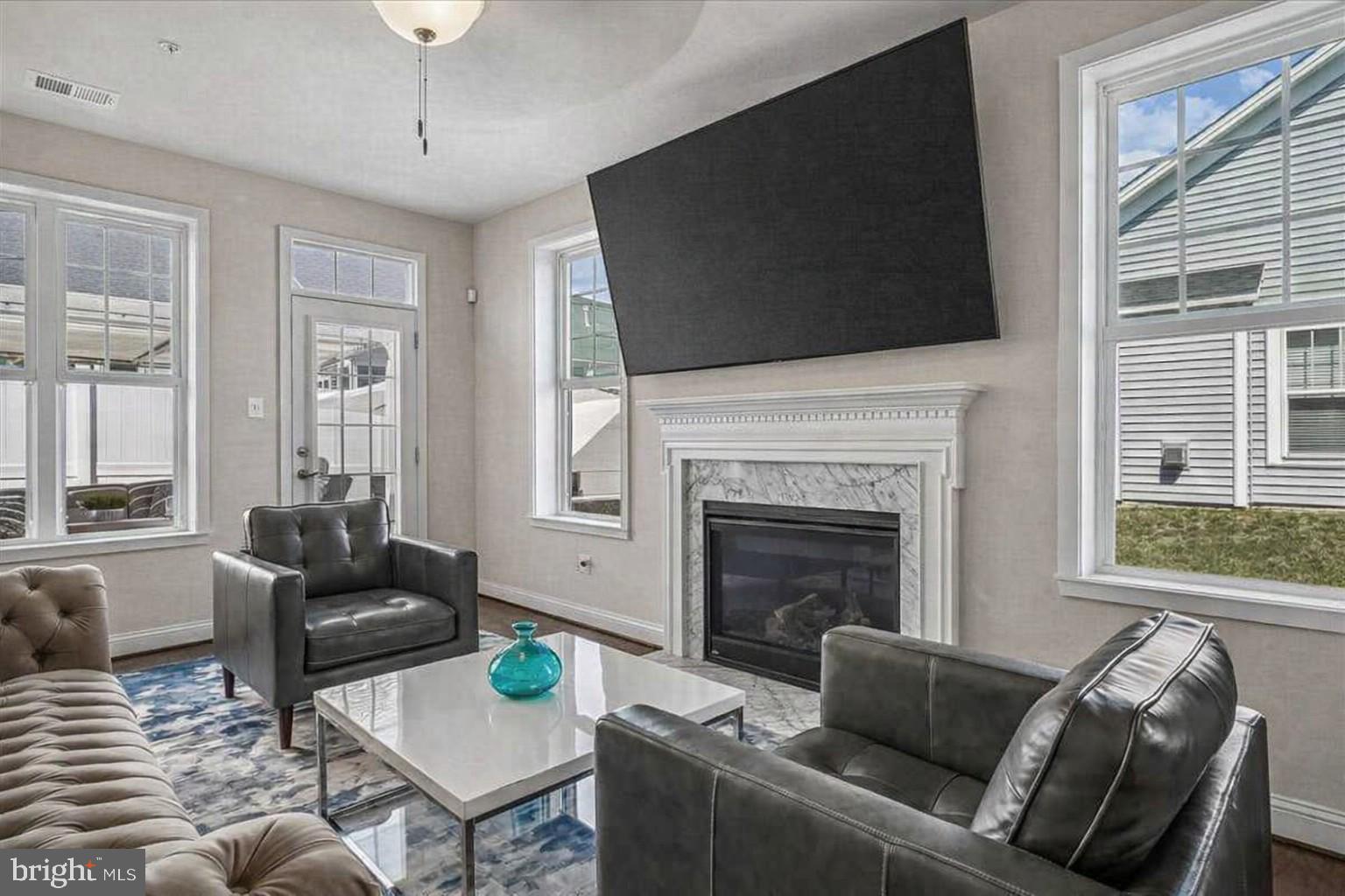 2638 Dragon Fly Way Odenton, MD 21113 - Photo 9 of 45 a living room with furniture a flat screen tv and a fireplace