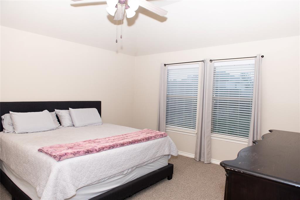 5125 Shelly Ray Road Fort Worth, TX 76244 - Photo 13 of 27 Bedroom with light colored carpet and ceiling fan