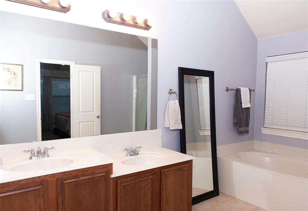 5125 Shelly Ray Road Fort Worth, TX 76244 - Photo 14 of 27 Bathroom with a garden tub, double vanity, light tile patterned floors, and a shower stall