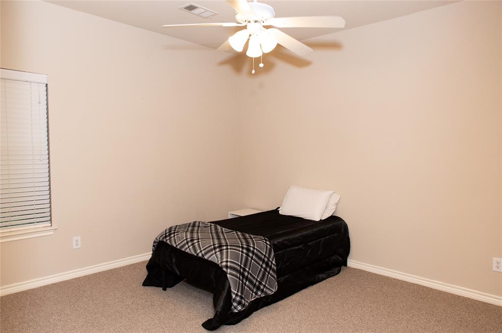 5125 Shelly Ray Road Fort Worth, TX 76244 - Photo 17 of 27 Carpeted bedroom with baseboards and ceiling fan