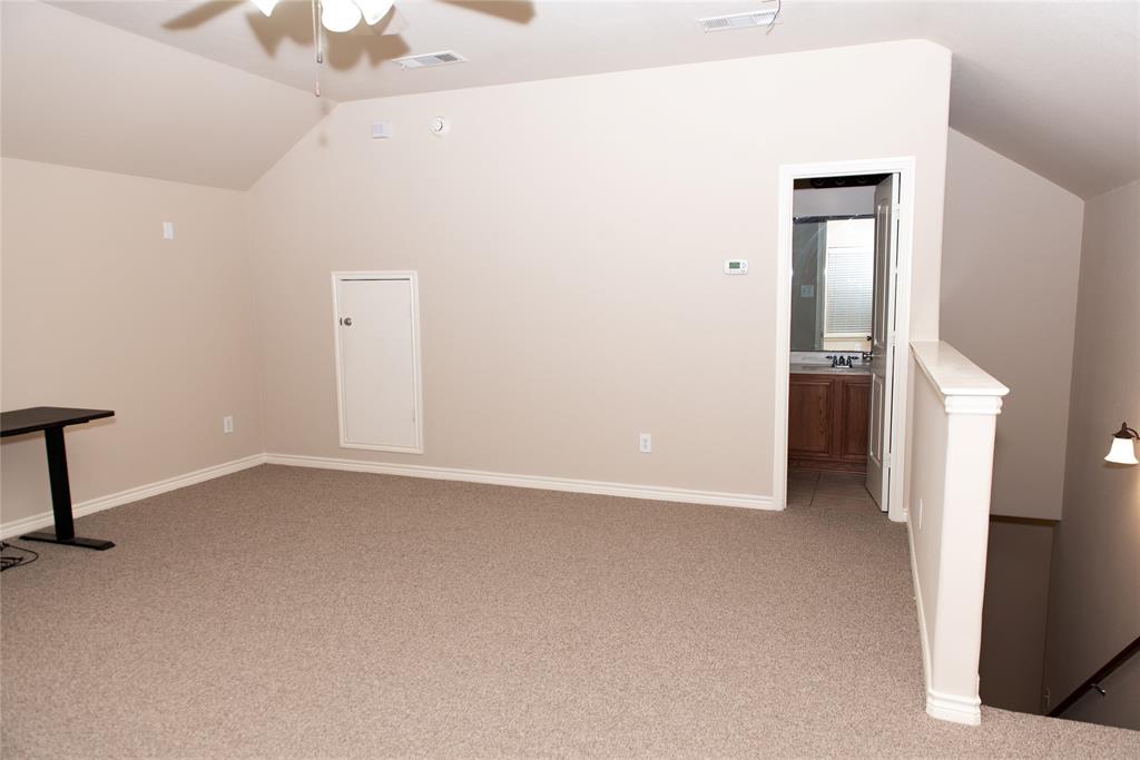 5125 Shelly Ray Road Fort Worth, TX 76244 - Photo 20 of 27 Additional living space with vaulted ceiling, light colored carpet, and a ceiling fan