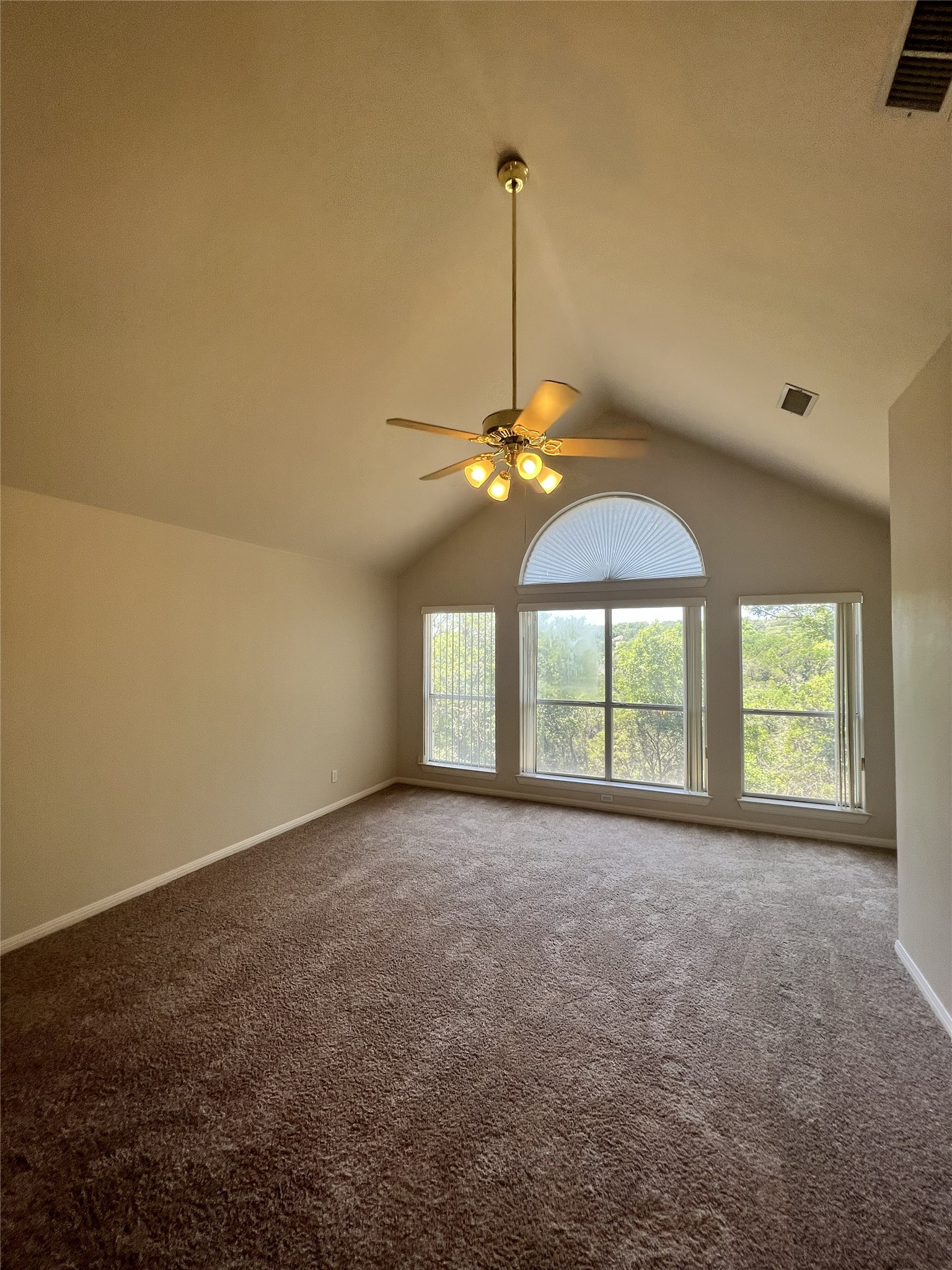 9405 Ashton Ridge Austin, TX 78750 - Photo 7 of 22 Naturally illuminated interiors boast vaulted ceilings and a serene green view, perfect for peaceful living.