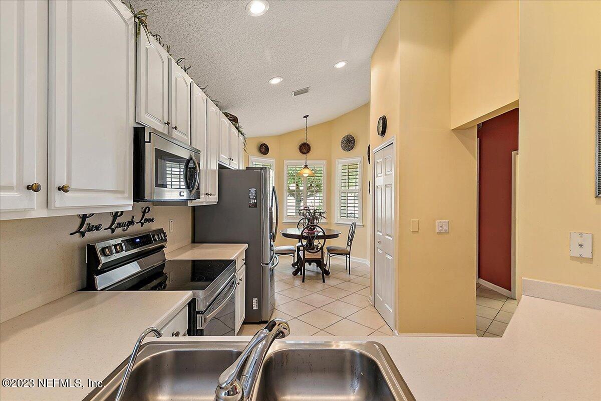 694 Copperhead Circle St. Augustine, FL 32092 - Photo 11 of 27 a room with furniture a flat screen tv and a sink