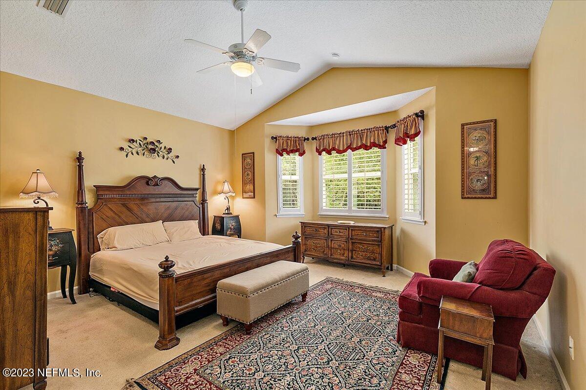 694 Copperhead Circle St. Augustine, FL 32092 - Photo 15 of 27 a bedroom with a bed and chair
