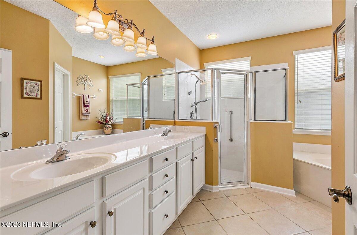 694 Copperhead Circle St. Augustine, FL 32092 - Photo 16 of 27 a spacious bathroom with a double vanity sink mirror and shower