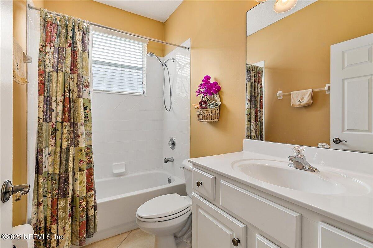 694 Copperhead Circle St. Augustine, FL 32092 - Photo 19 of 27 a bathroom with a sink toilet vanity and shower