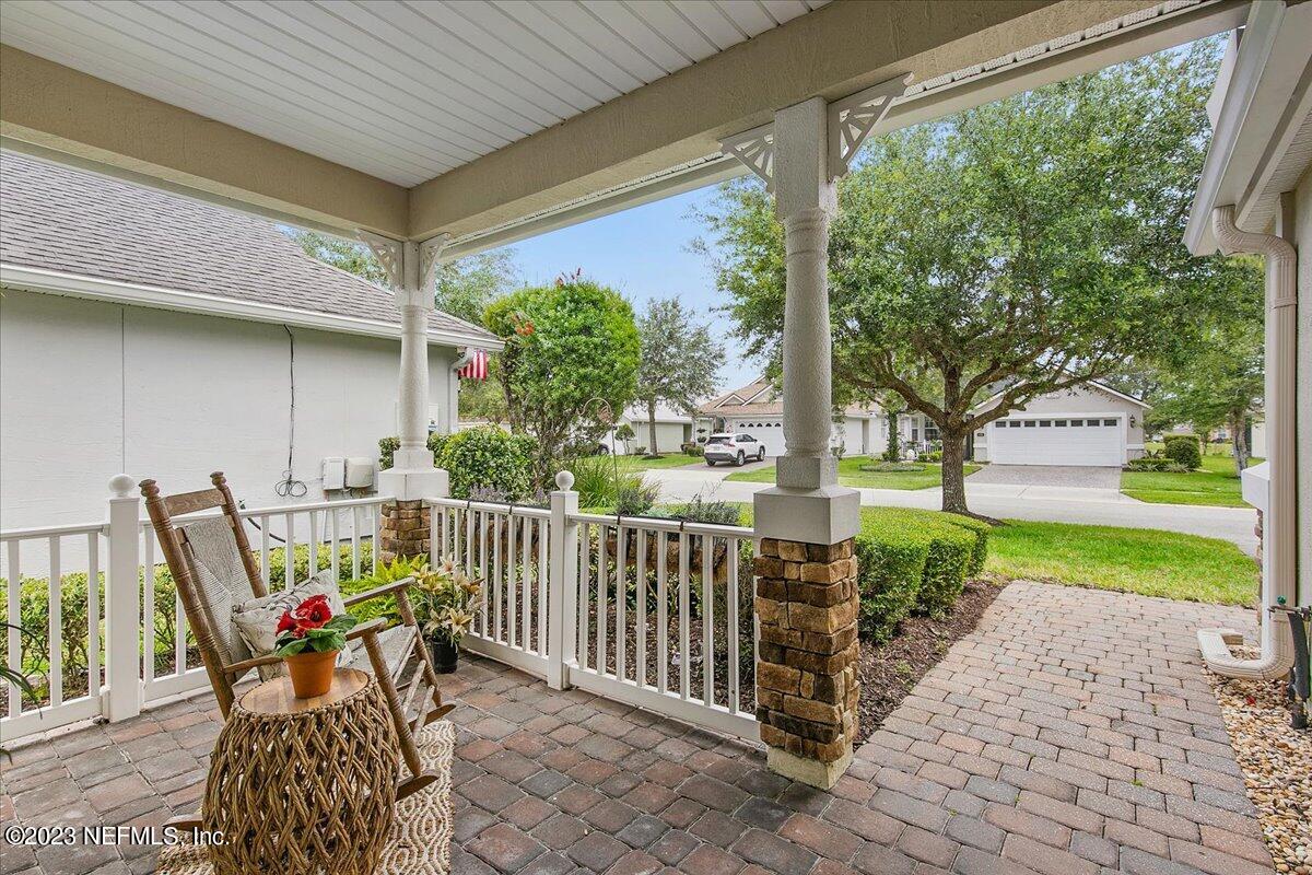 694 Copperhead Circle St. Augustine, FL 32092 - Photo 5 of 27 a roof deck with table and chairs and potted plants