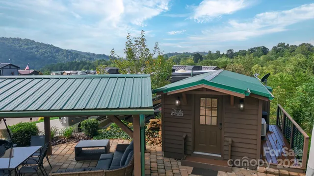 a backyard of a house with wooden floor and outdoor seating