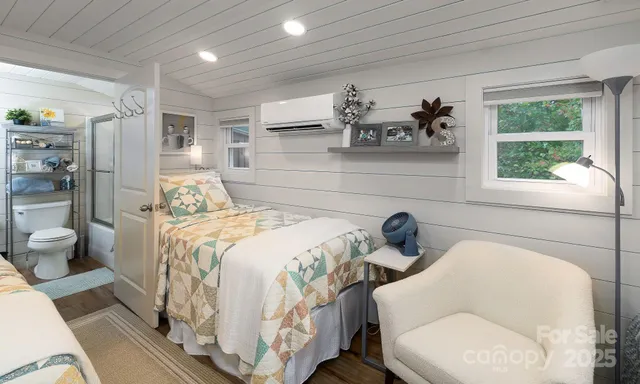 a bedroom with a large bed and a window