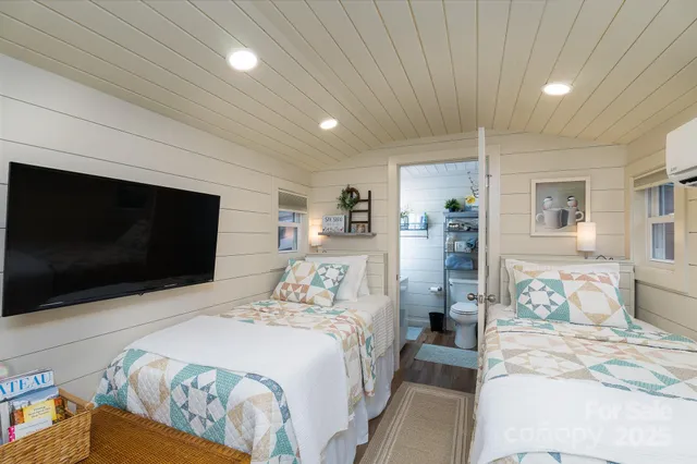 a bedroom with a bed and a flat screen tv