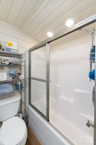 a bathroom with a toilet and a shower