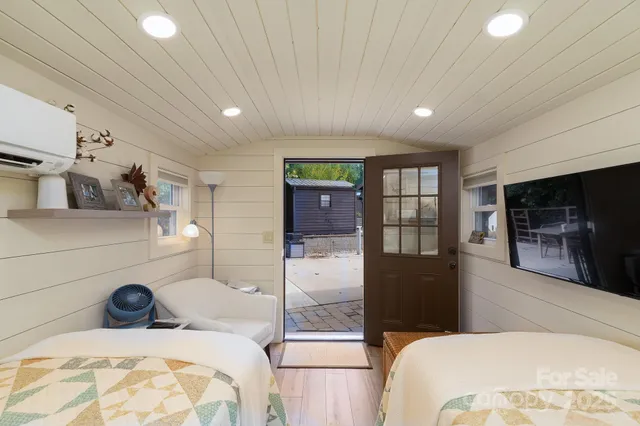 a bedroom with a bed and a large window