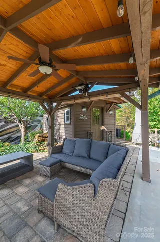 a view of patio with couches and pool