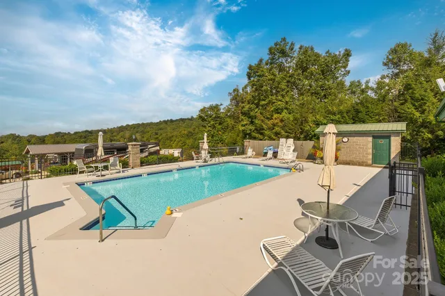 a view of a swimming pool with lawn chairs