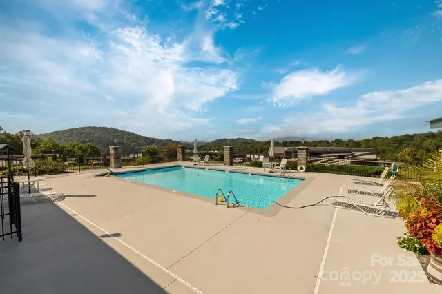 a view of a swimming pool with a lawn chairs