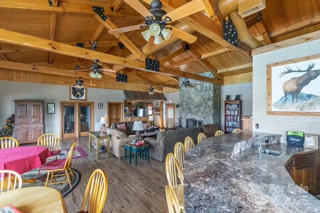 a view of a dining room with furniture a chandelier and wooden floor