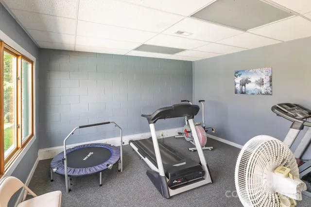 a room with a table chairs and a chandelier
