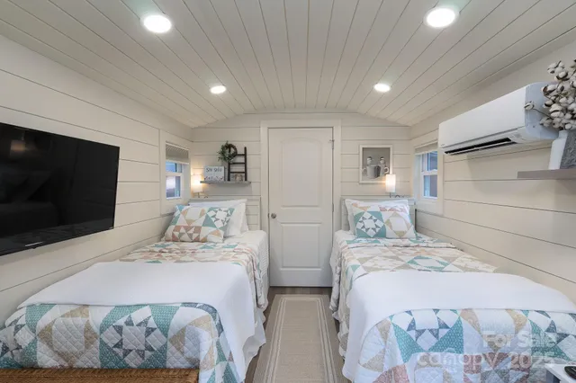 a bedroom with double bed and a flat screen tv