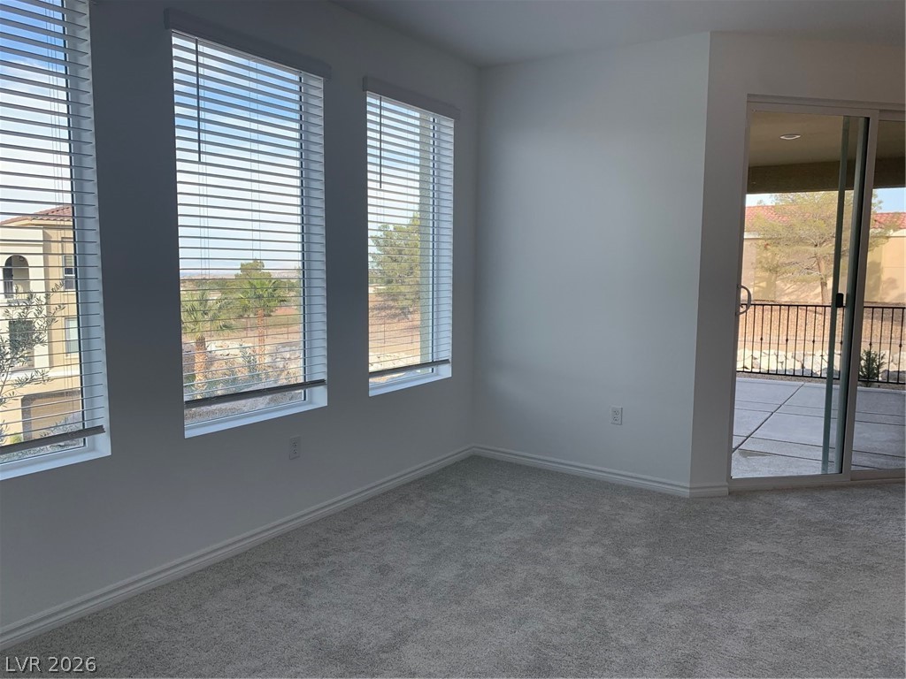 2555 Hampton Road, Unit 7109 Henderson, NV 89052 - Photo 23 of 34 A well-lit interior space with multiple windows and a sliding glass door provides abundant natural light.