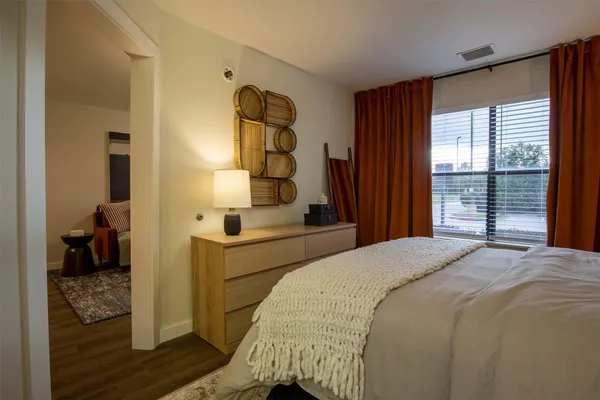 a bedroom with a bed and large windows