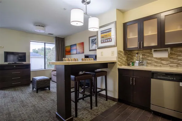 a kitchen with a sink cabinets and window