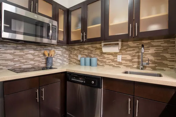 a kitchen with stainless steel appliances granite countertop a sink and cabinets