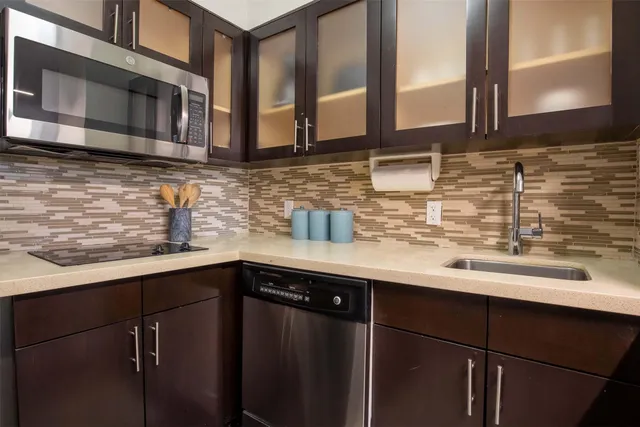 a kitchen with stainless steel appliances granite countertop a sink and cabinets