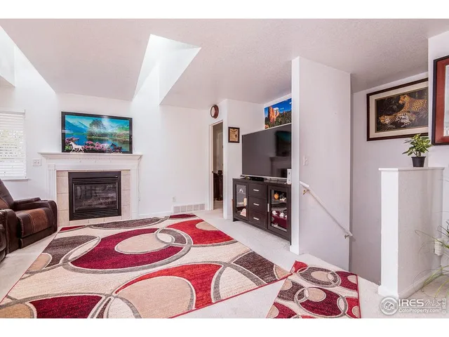 a bedroom with a bed and a television