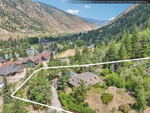 an aerial view of a residential houses with yard