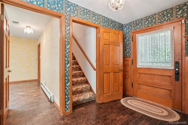 a view of a room with wooden floor and windows