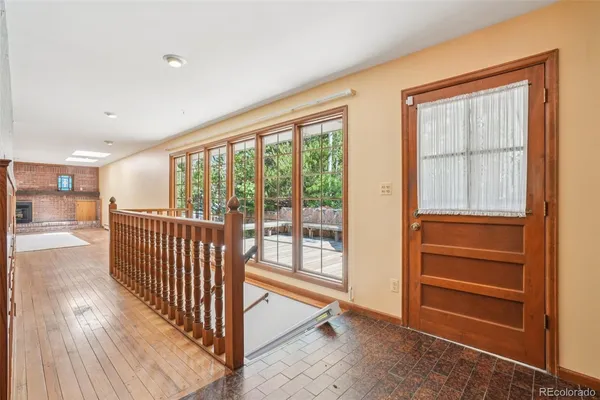 a view of a hallway with stairs and furniture
