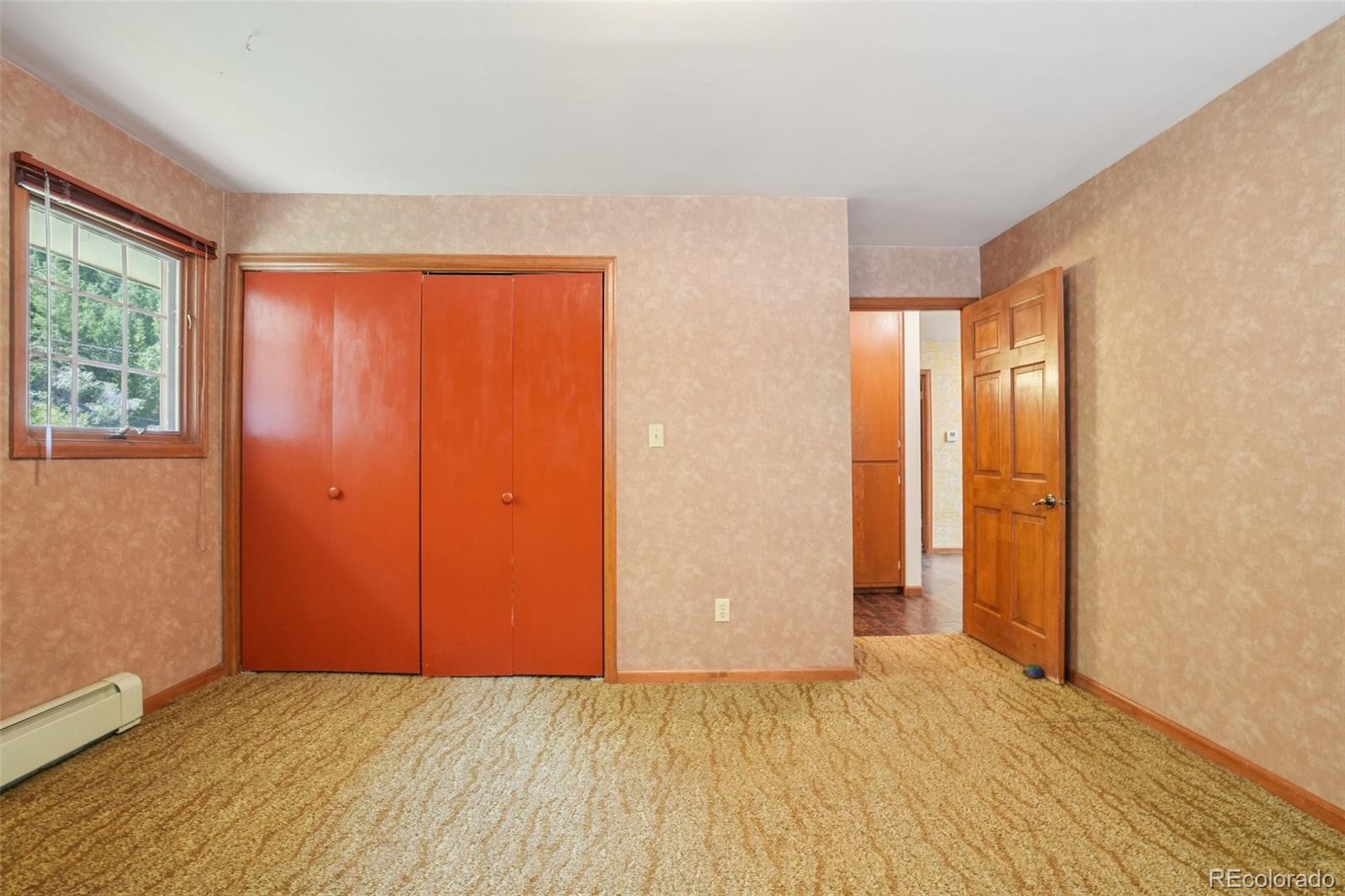 203 Ninth Street Georgetown, CO 80444 - Photo 34 of 44 an empty room with wooden floor and windows