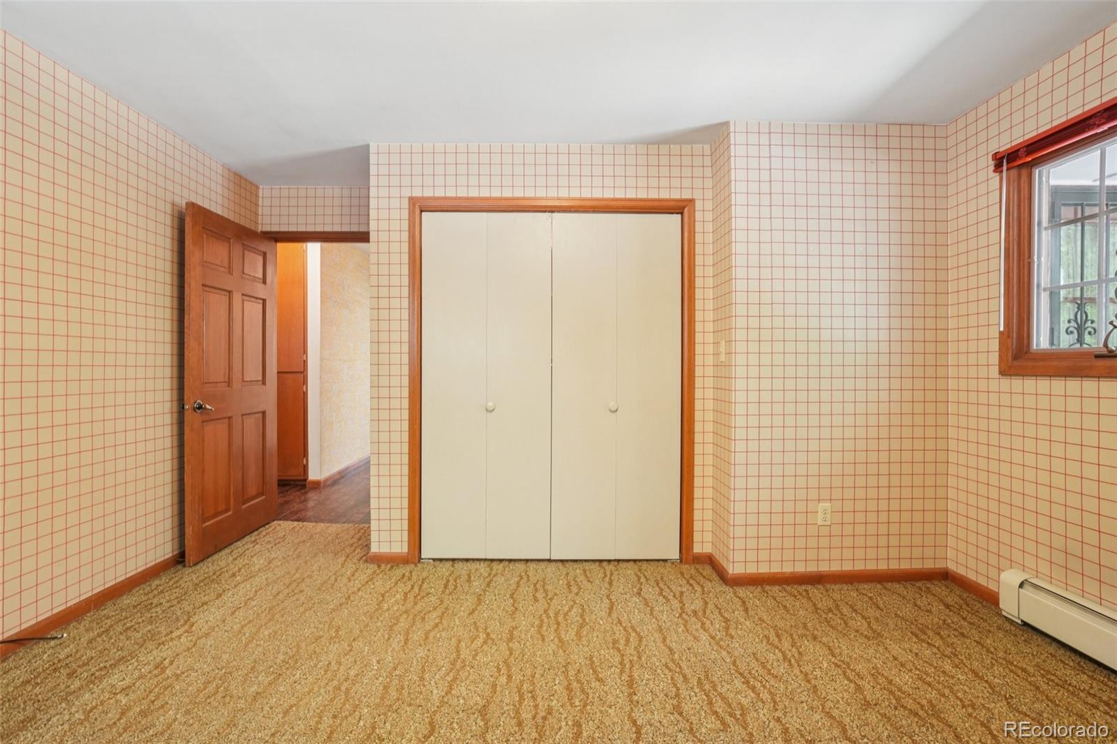 203 Ninth Street Georgetown, CO 80444 - Photo 35 of 44 an empty room with wooden floor and windows