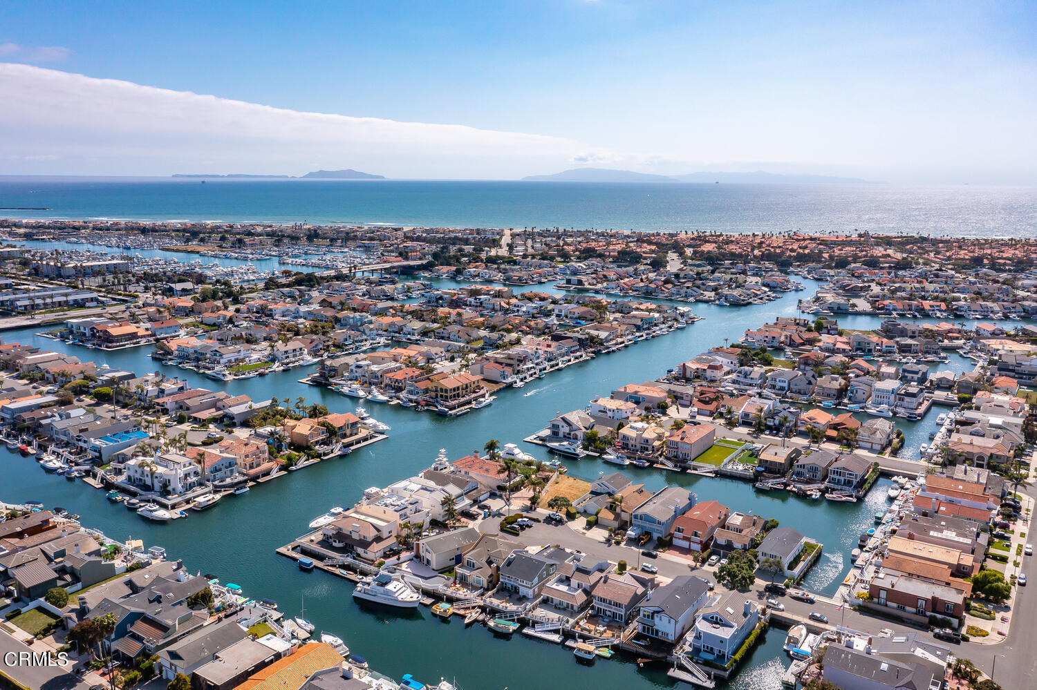 2101 Napoli Drive Oxnard, CA 93035 - Photo 3 of 50 an aerial view of a city with lots of residential buildings and ocean view in back