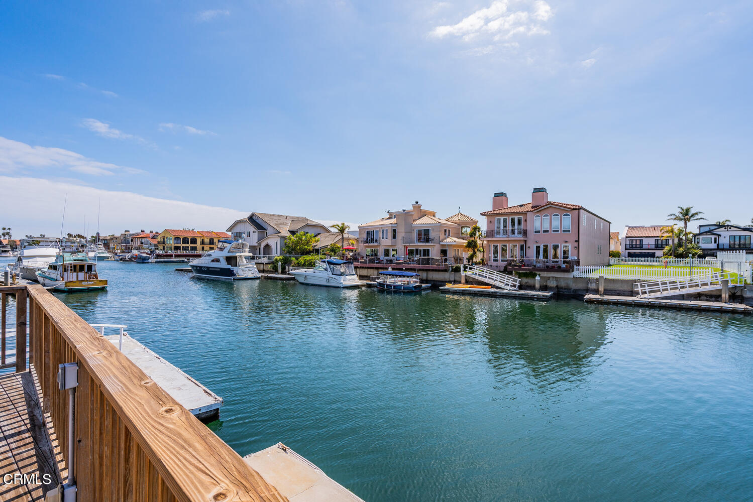 2101 Napoli Drive Oxnard, CA 93035 - Photo 42 of 50 a view of a lake with boats and trees in the background