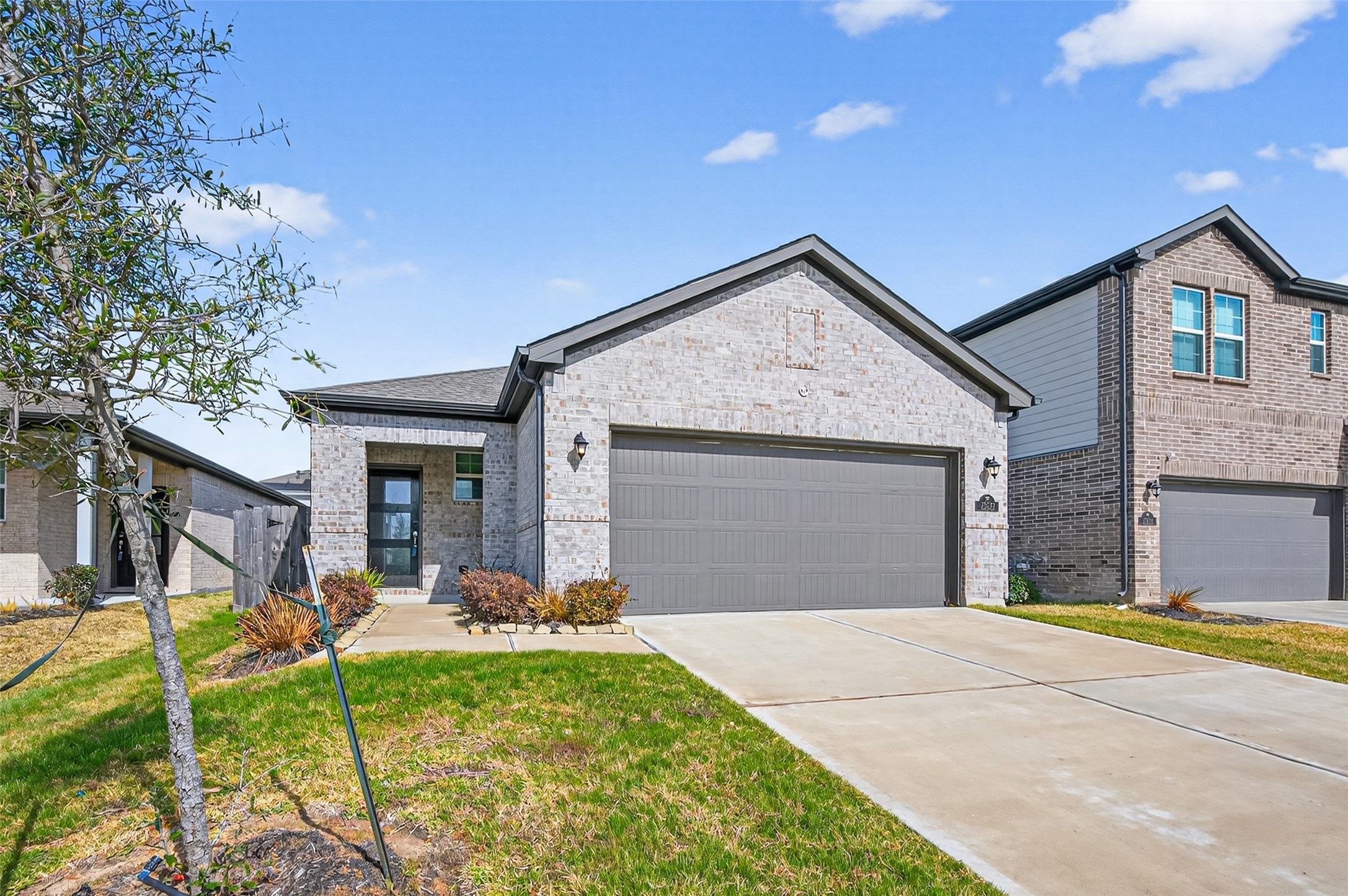 23222 Spring Genesis Lane Katy, TX 77493 - Photo 2 of 43 Three-quarter brick home nestled in the desirable Century Communities, offering a blend of classic charm and modern living.
