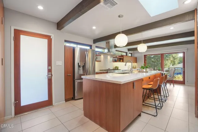 a kitchen with stainless steel appliances granite countertop a stove and a refrigerator
