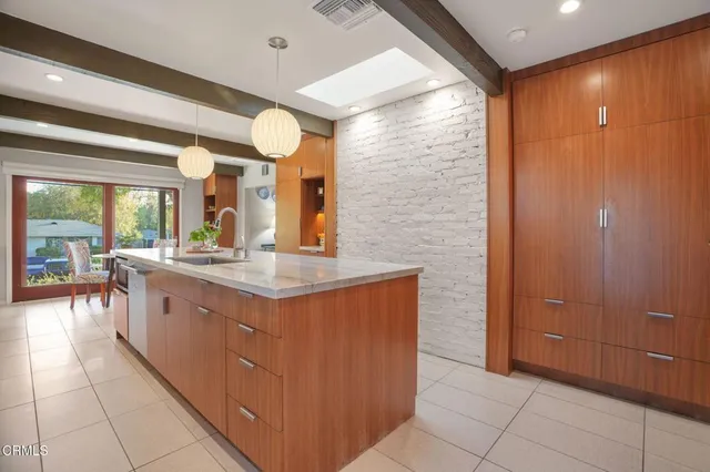 a bathroom with a granite countertop sink and a large mirror