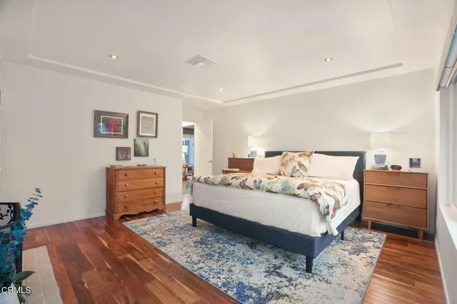 a bedroom with a bed and a dresser