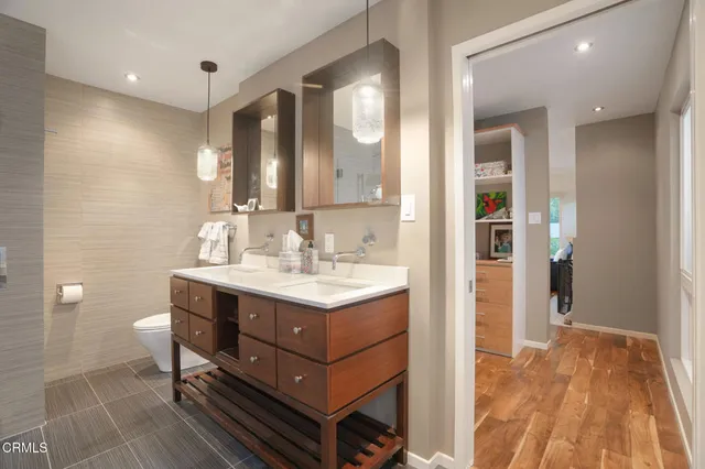 a bathroom with a sink mirror and a shower